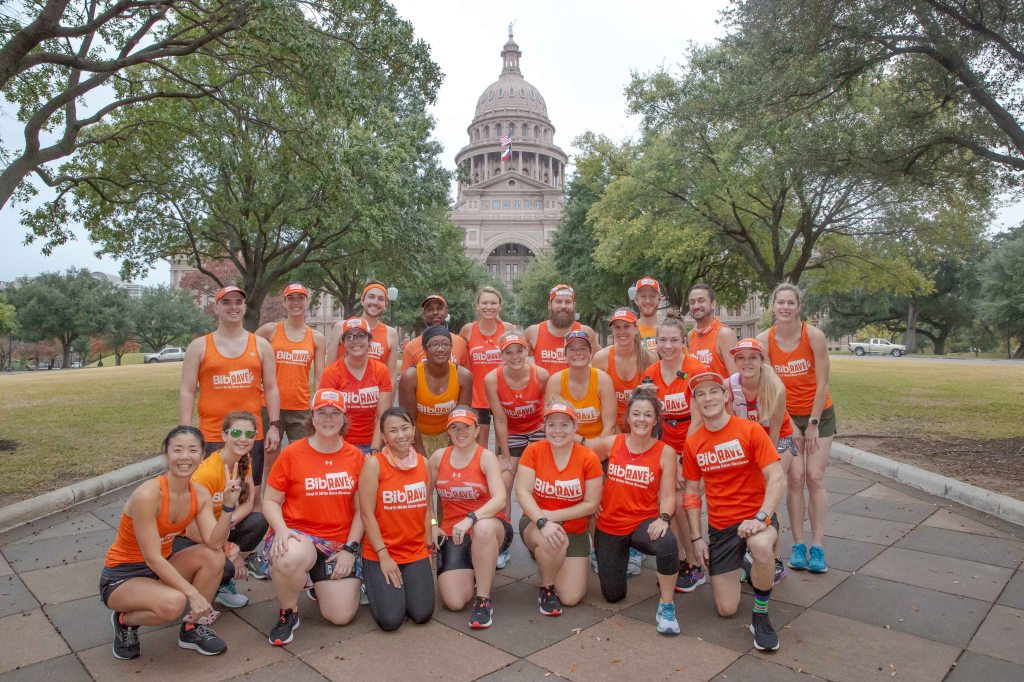 Group of BibRave Pros and Team BibRave pose in front of the Texas State Capitol building. 