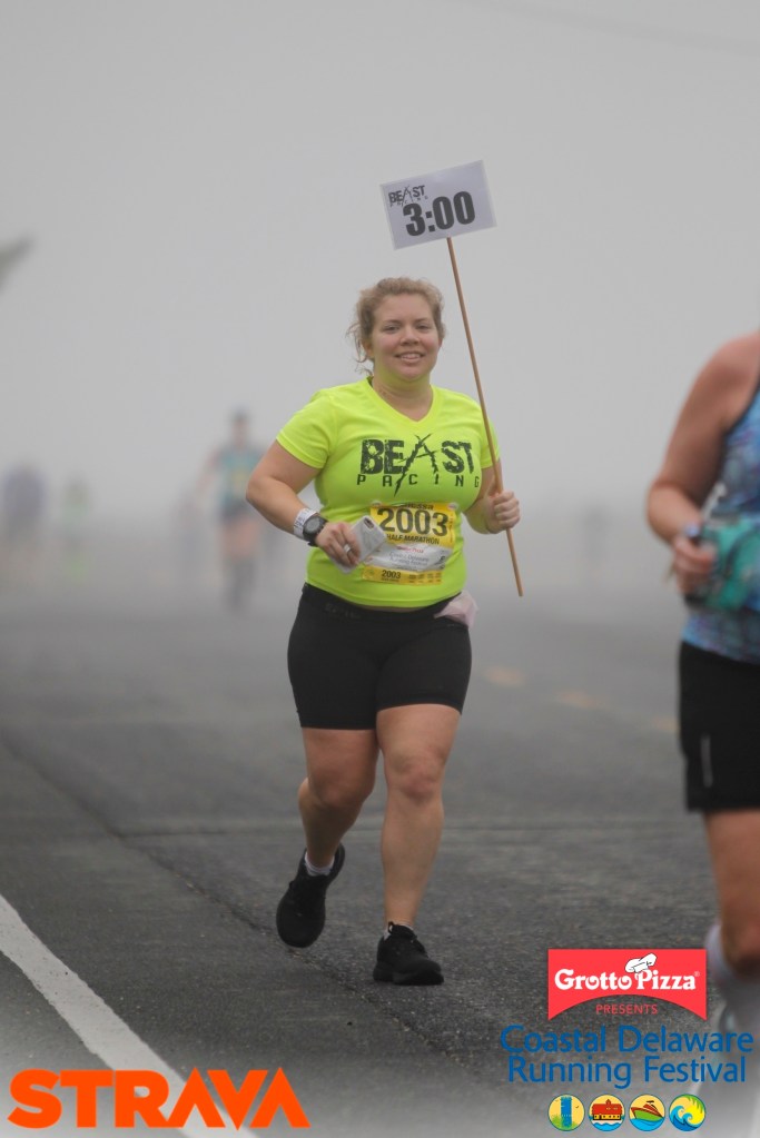 Vanessa Junkin is shown in pacer shirt and with 3:00 sign on a foggy day. 
