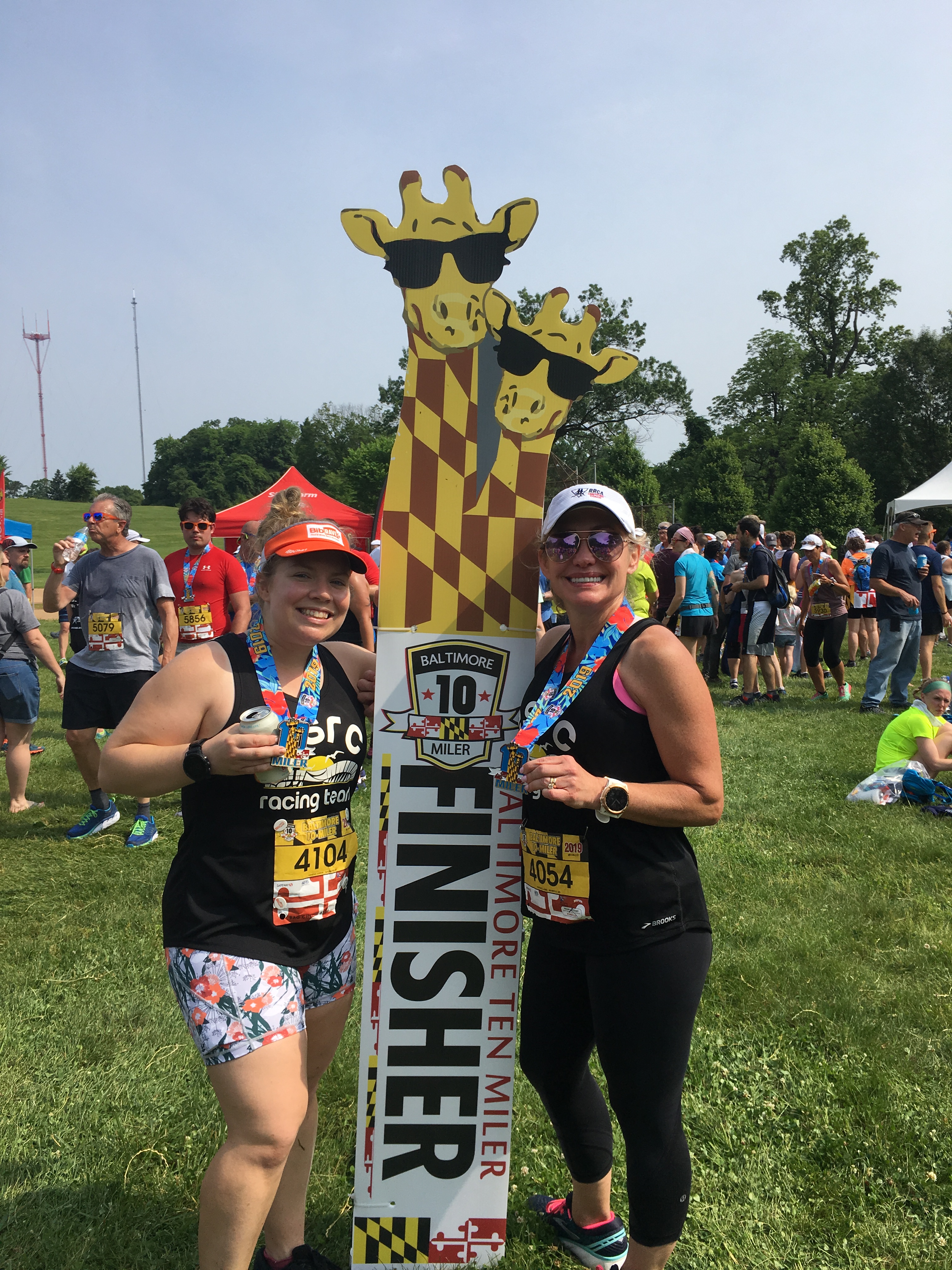 Vanessa and Veronica posing with Baltimore 10 Miler finisher photo op. 