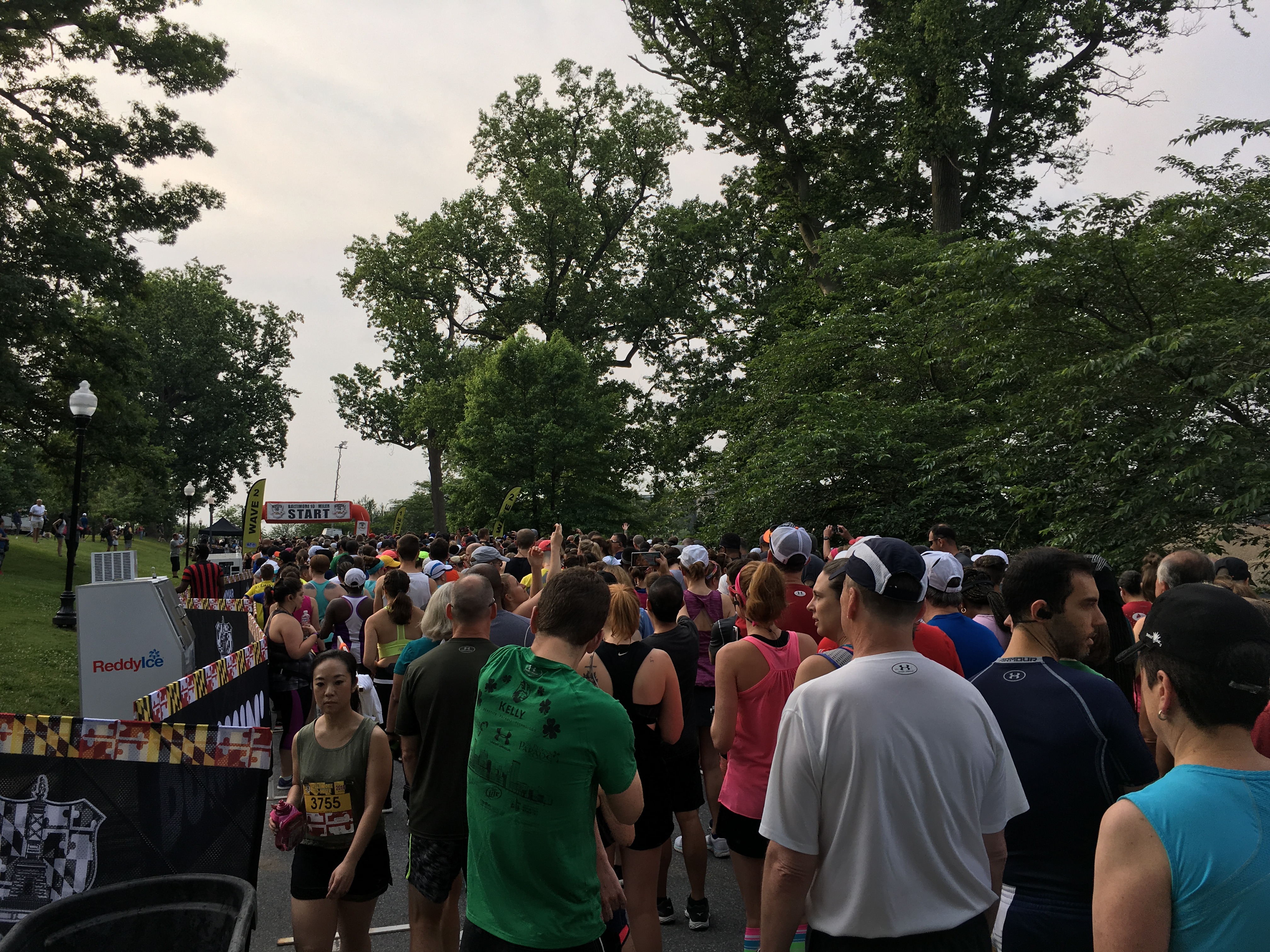 Starting corral for the Baltimore 10 Miler, showing large group of people and starting arch. 