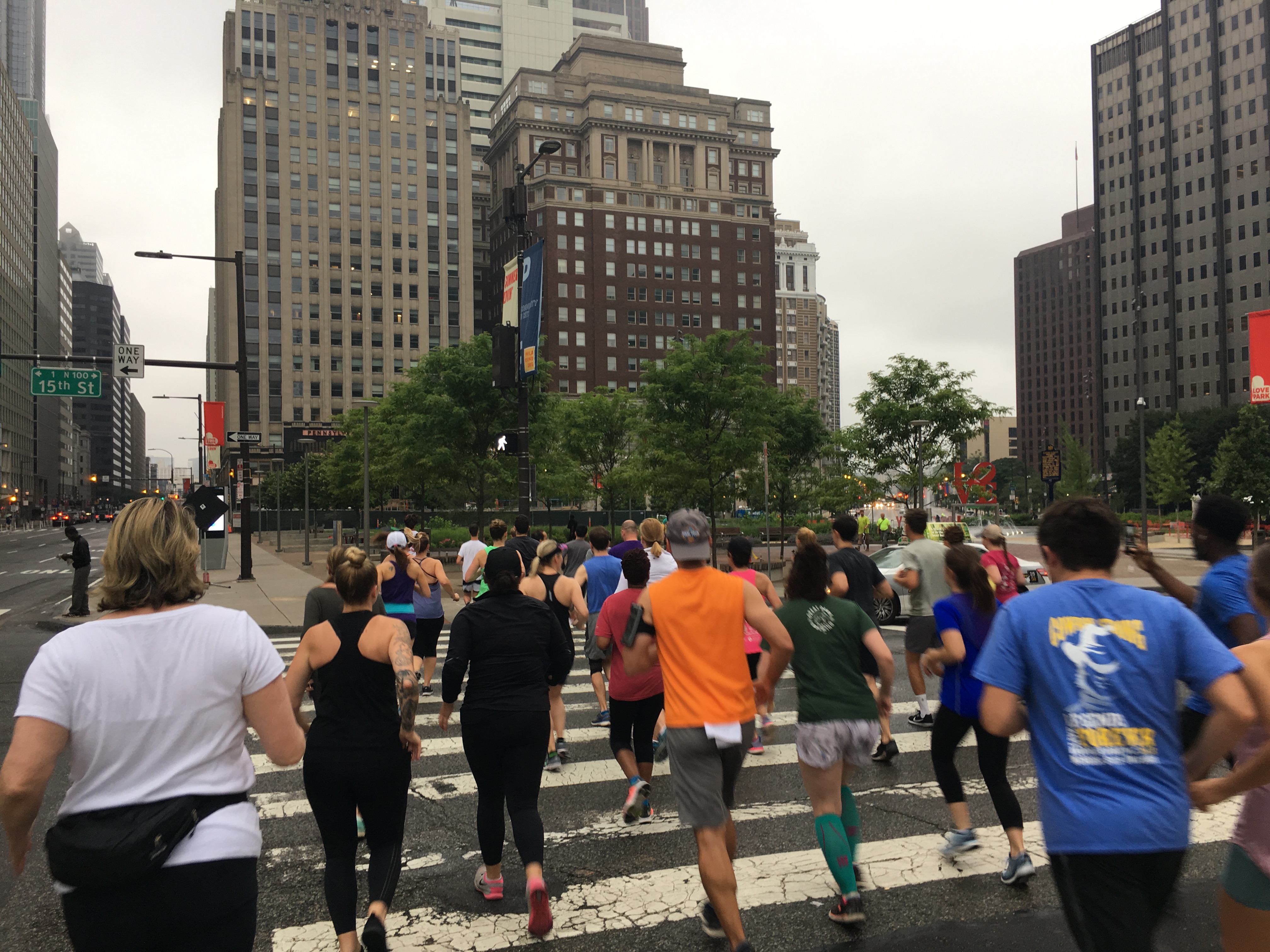 Runners cross a crosswalk in Philadelphia.