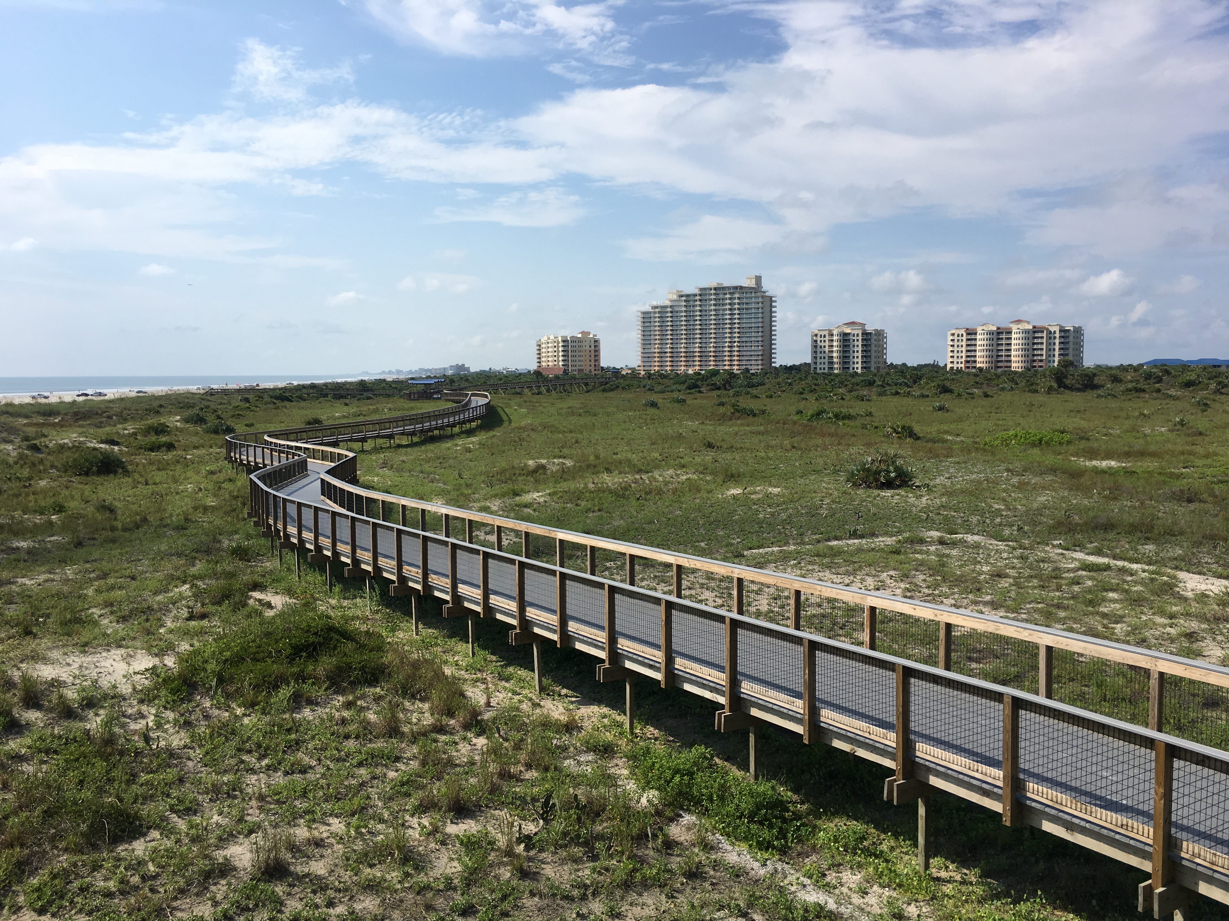 View of Smyrna Dunes Park boardwalk and condos/hotels in teh distance. 