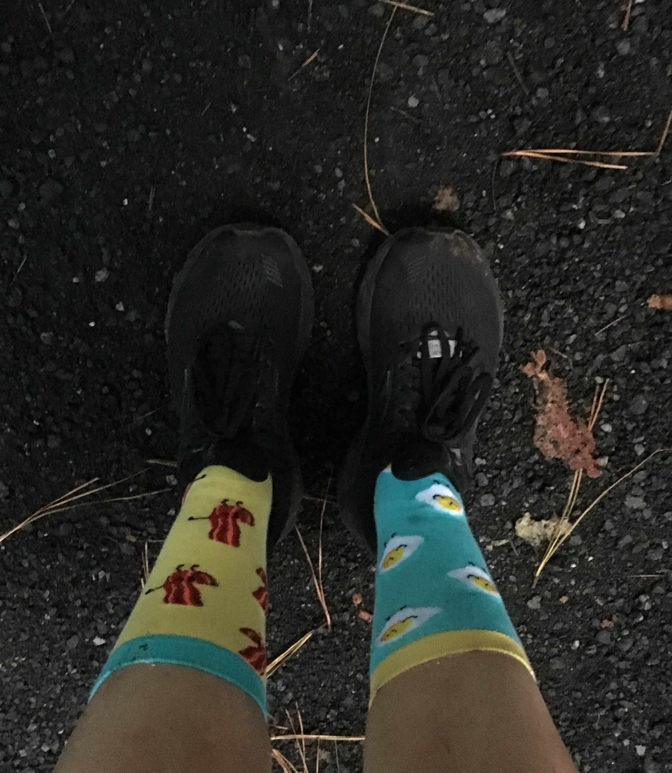 Picture of Vanessa's bacon and egg socks. The left sock has bacon on it, and the right sock has eggs on it. 