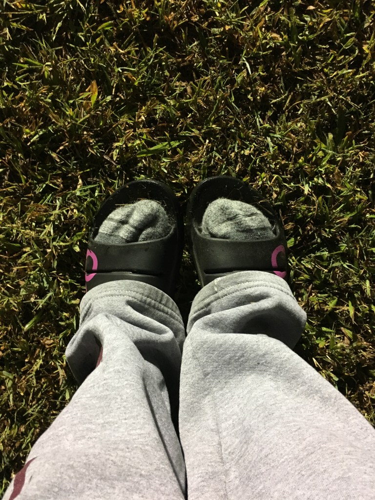 View of Vanessa's feet in socks in the OOFOS slides.