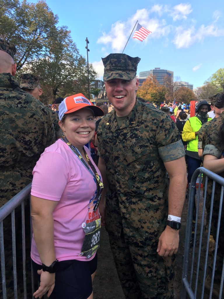 Vanessa Junkin poses with the Marine who gave her a finisher medal.