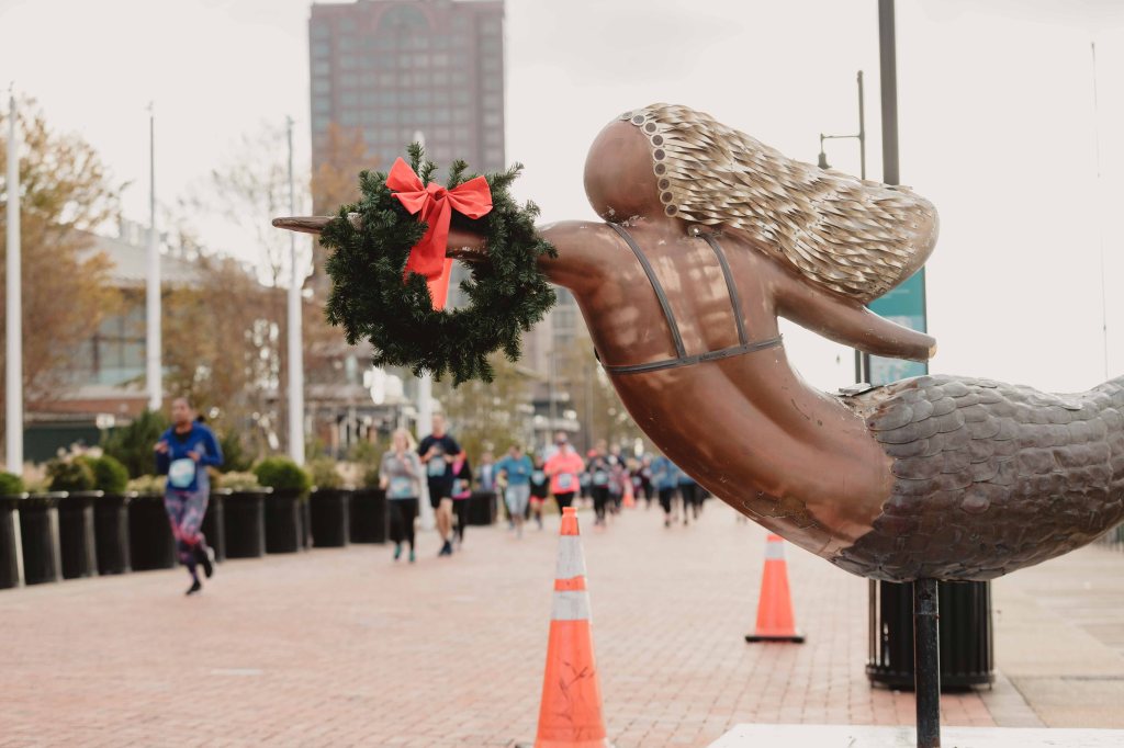 Mermaid statue in Norfolk with a wreath on it