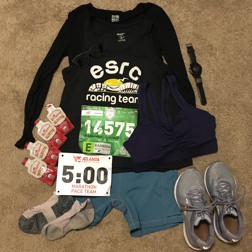 Race outfit, gels, shoes, socks, race bib, pace time bib and watch set out before race day.