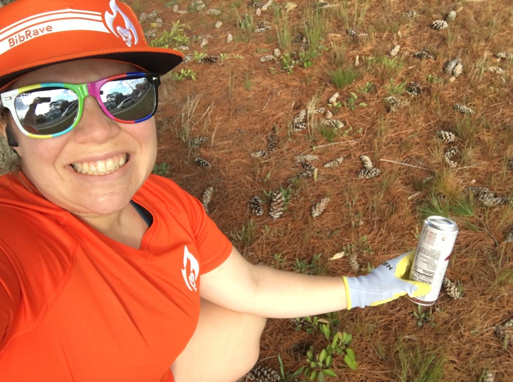 Vanessa Junkin grimaces as she picks up a can from the ground. 