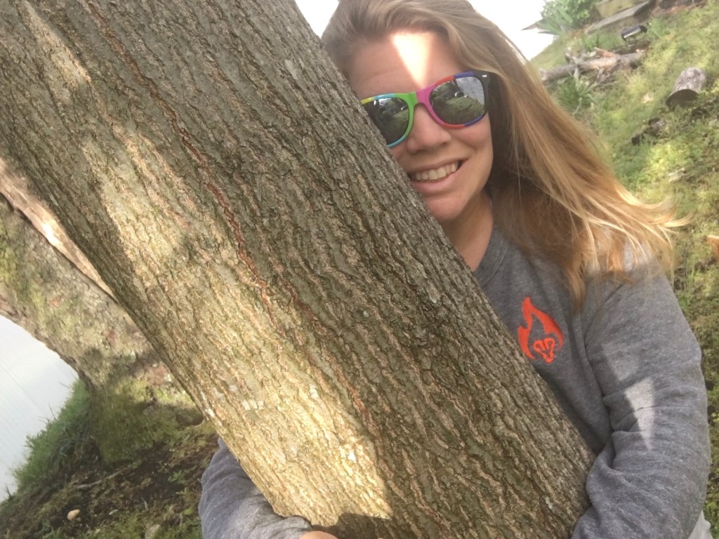 Selfie of Vanessa Junkin hugging a tree. 