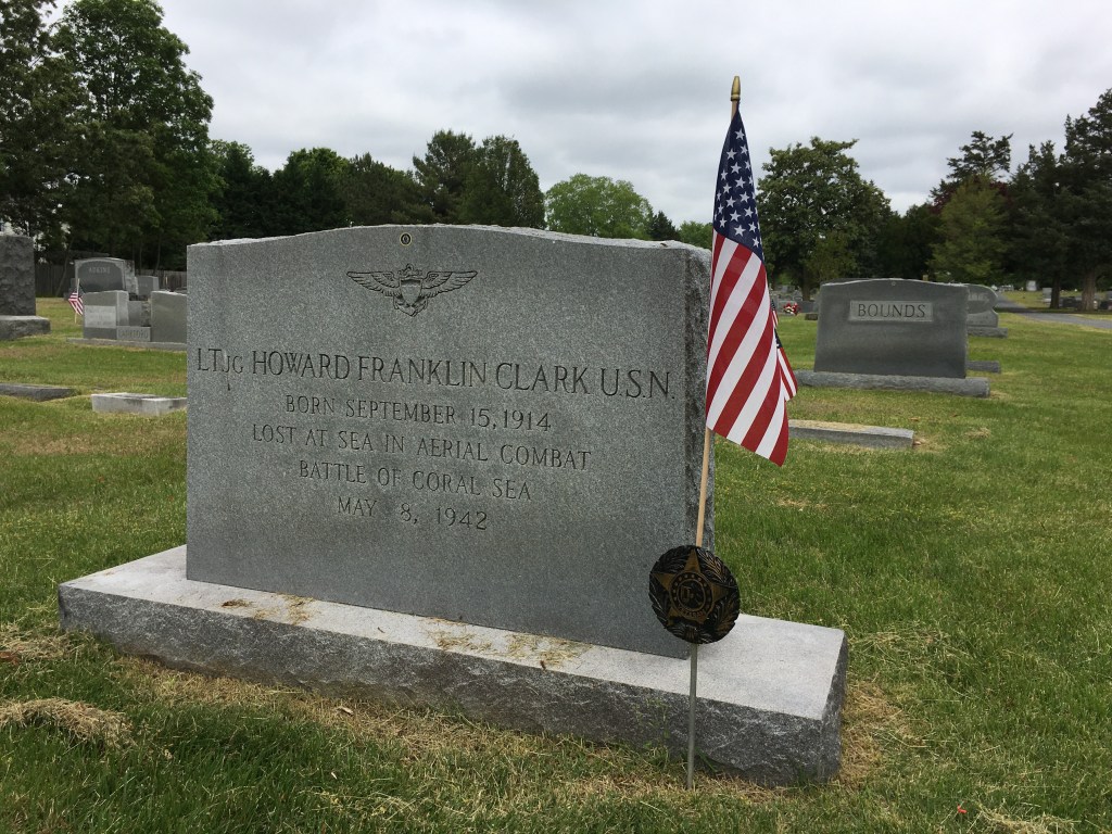 A grave with an American flag by it: 
It reads: 
LTJG Howard Franklin Clark USN
Born September 15, 1914 
Lost at Sea in Aerial Combat
Battle of Coral Sea
May 8, 1942