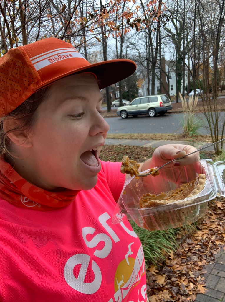 Vanessa Junkin opening her mouth to eat pumpkin pie off a fork and holding the pumpkin pie container. 