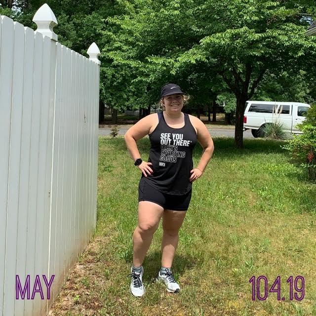 Vanessa Junkin posing in black tank top, shorts and hat. Text reads "May" and "104.19" for 104.19 miles.