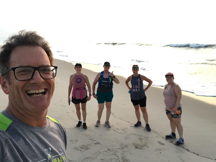 Group of runners in selfie on the beach. 