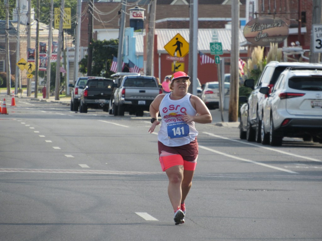 Vanessa Junkin running on the road with Crisfield in the background. 