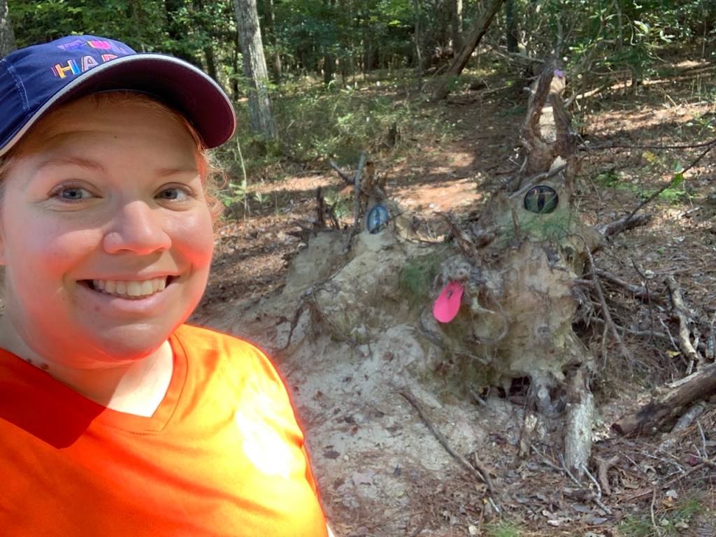 Selfie of Vanessa Junkin with cat made out of mud. 