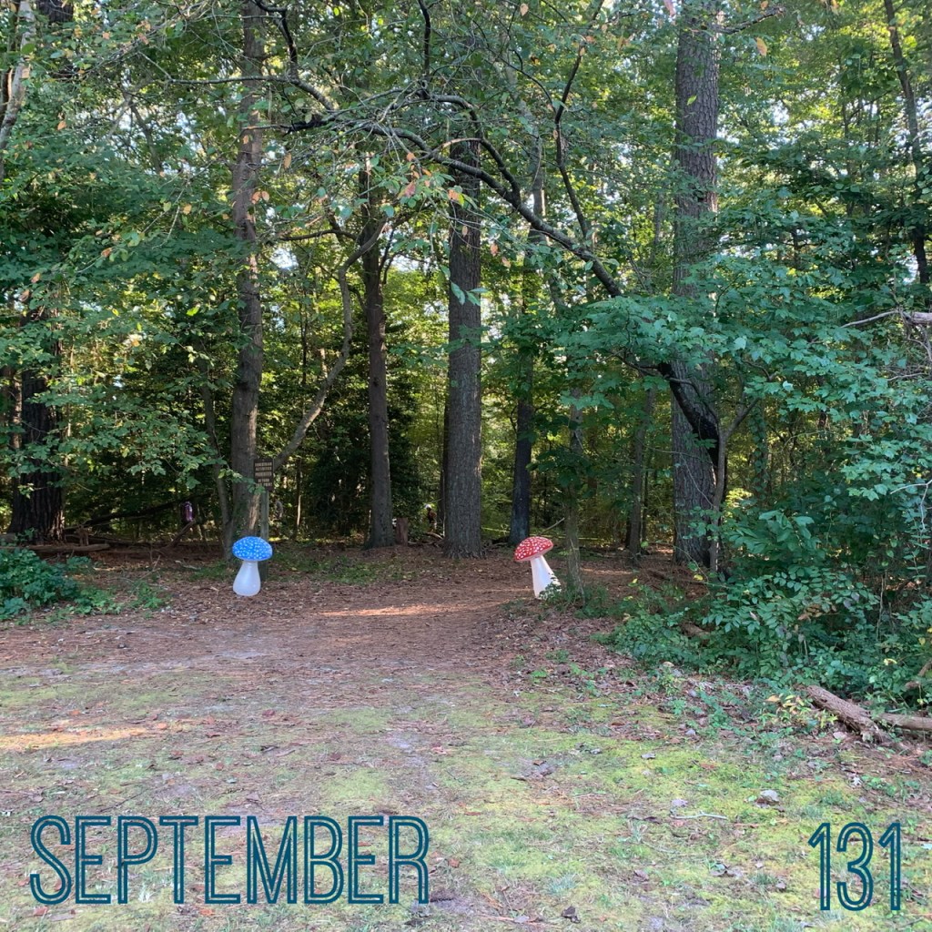 Photo of two inflatable mushrooms at the entrance to a trail in Pemberton Park. Text reads "September" and "131." 
