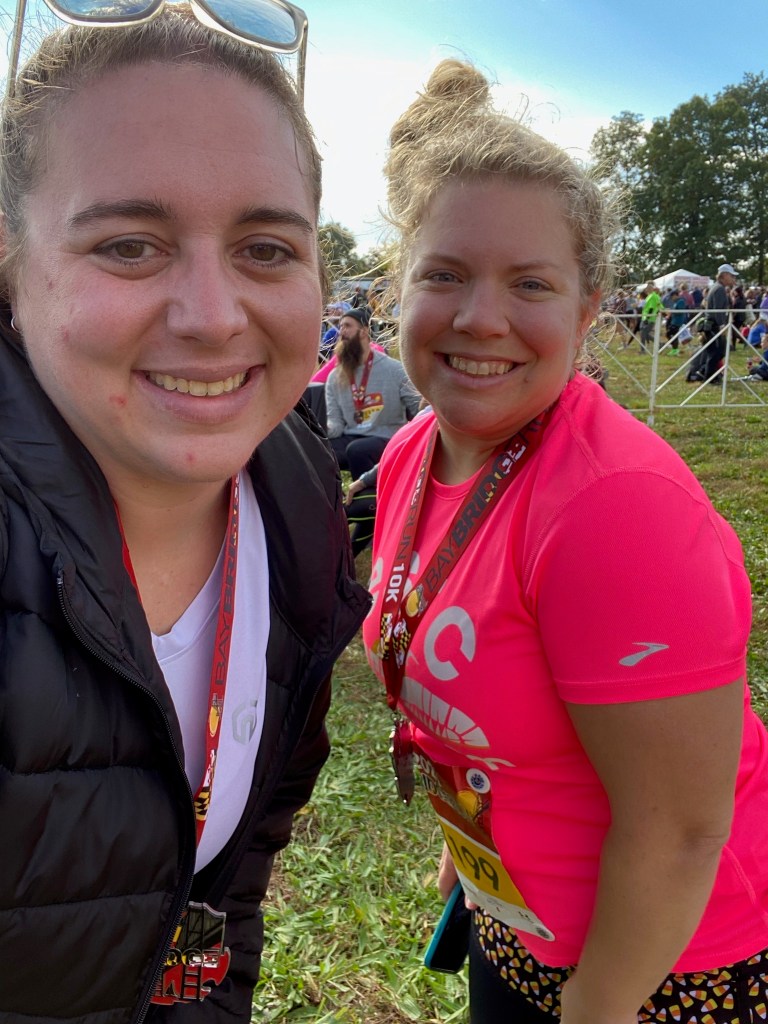 Selfie of two runners wearing race medals. 