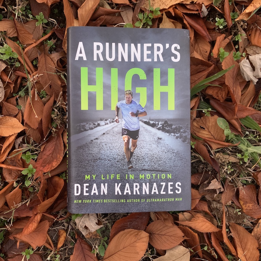 The book "A Runner's High" by Dean Karnazes against a background of fall leaves.