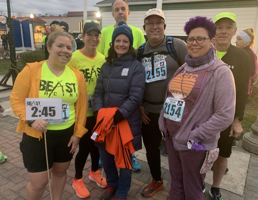 A group of seven runners pose for a photo. 