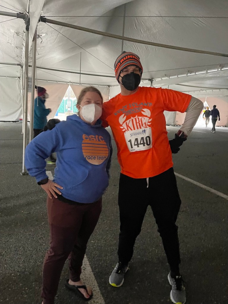 Photo of two runners inside a tent. 