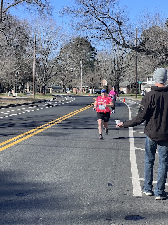 Vanessa Junkin runs toward a water stop. 