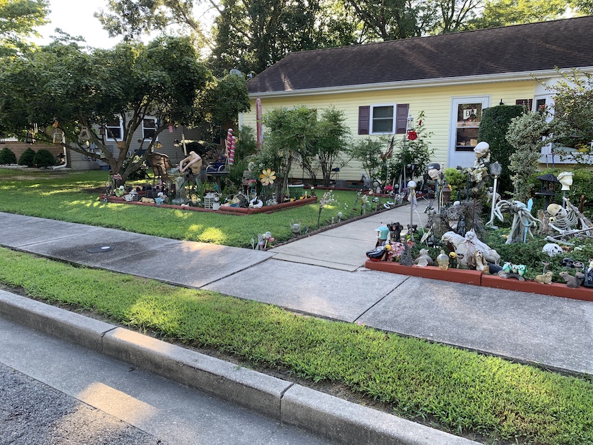 Various skeletons and other decorations in a front yard. 