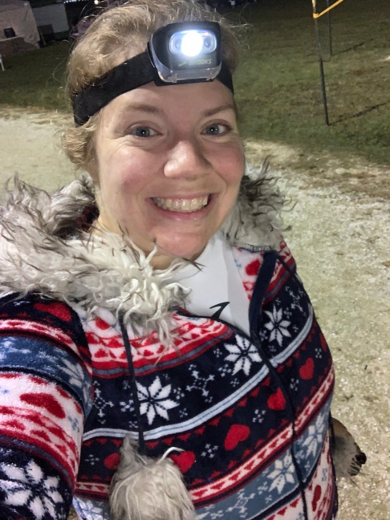 Selfie of Vanessa Junkin with headlamp and fuzzy onesie.