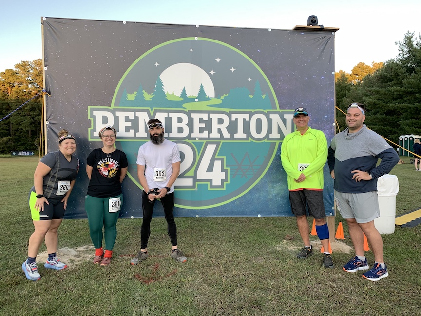 Five runners pose around Pemberton 24 sign.