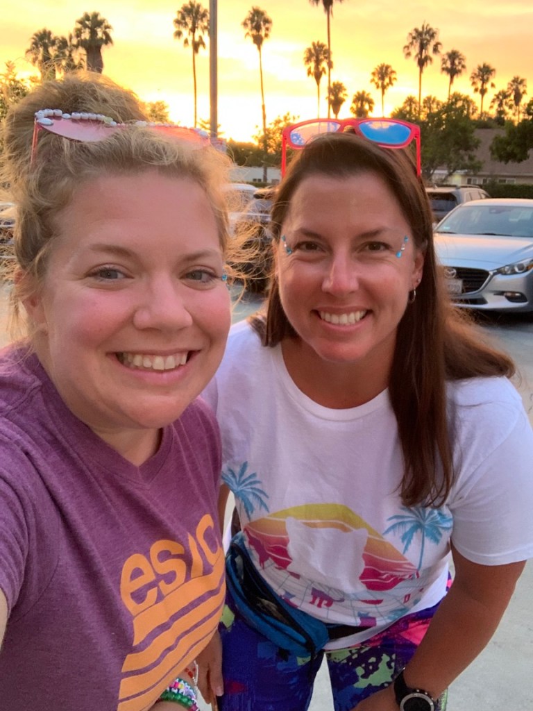 Selfie of Vanessa and Bonnie in vaporwave outfits outside.