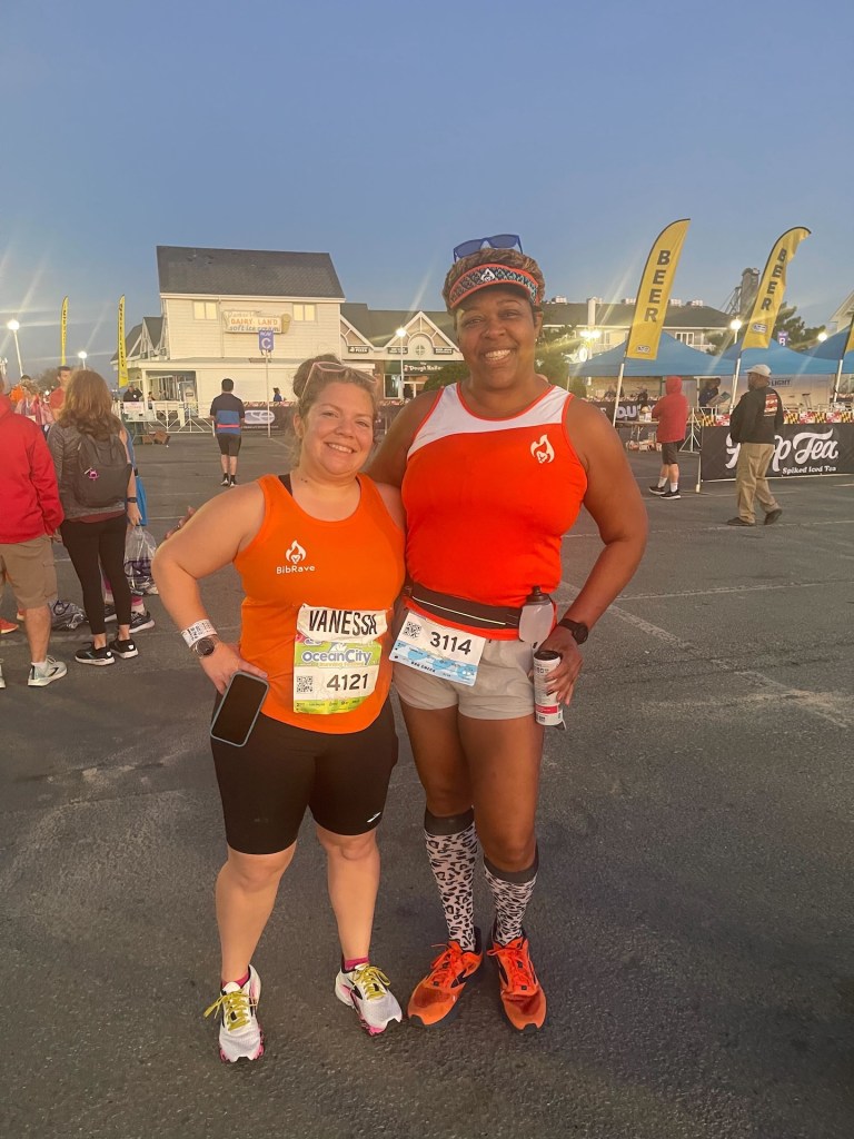 Vanessa and Krista, in orange BibRave shirts, pose for a photo. 