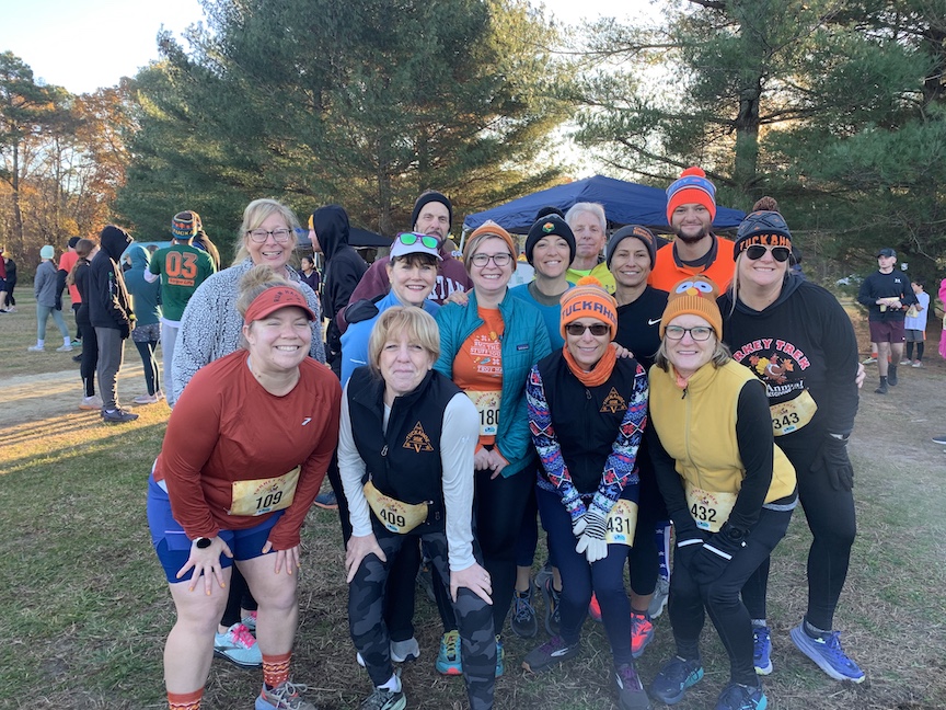 A group of runners pose for a photo before the Turkey Trek 5K. 