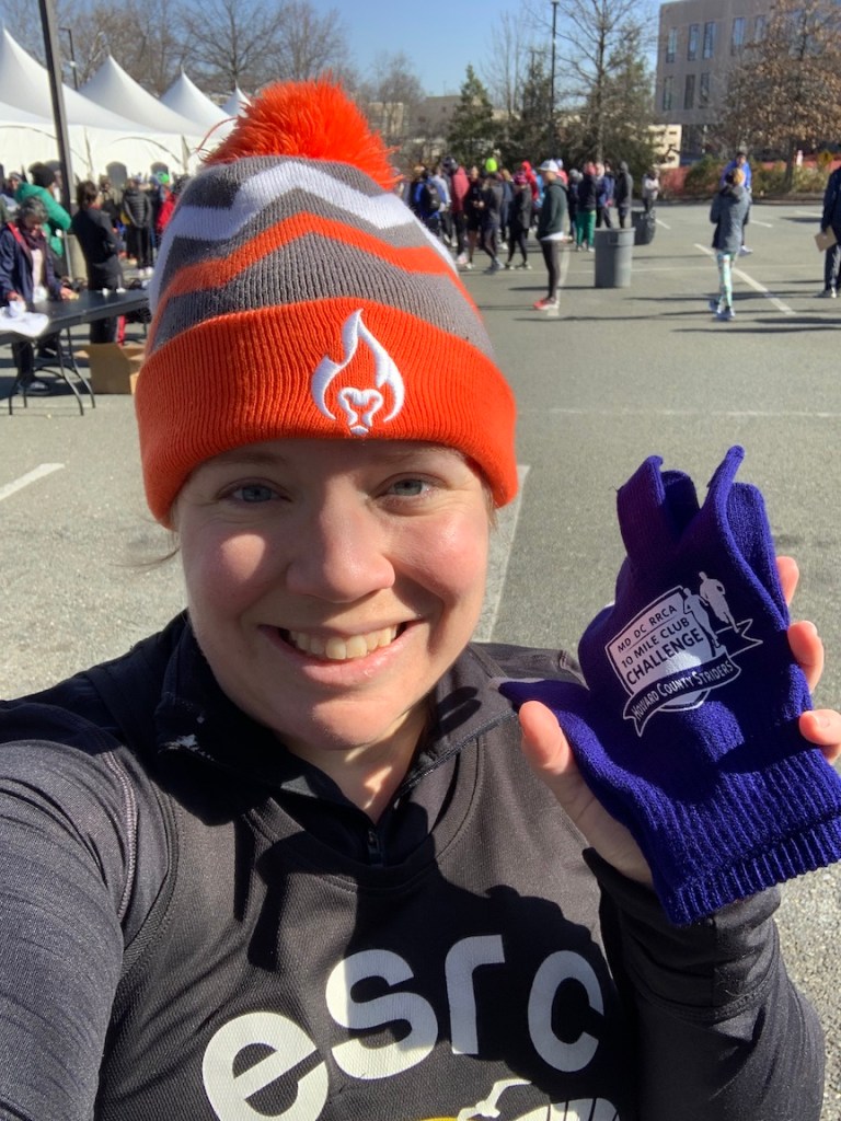 Selfie of Vanessa Junkin holding a pair of gloves. 