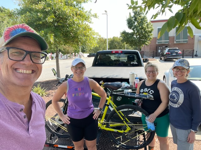 Four people pose for a selfie after completing a run. 