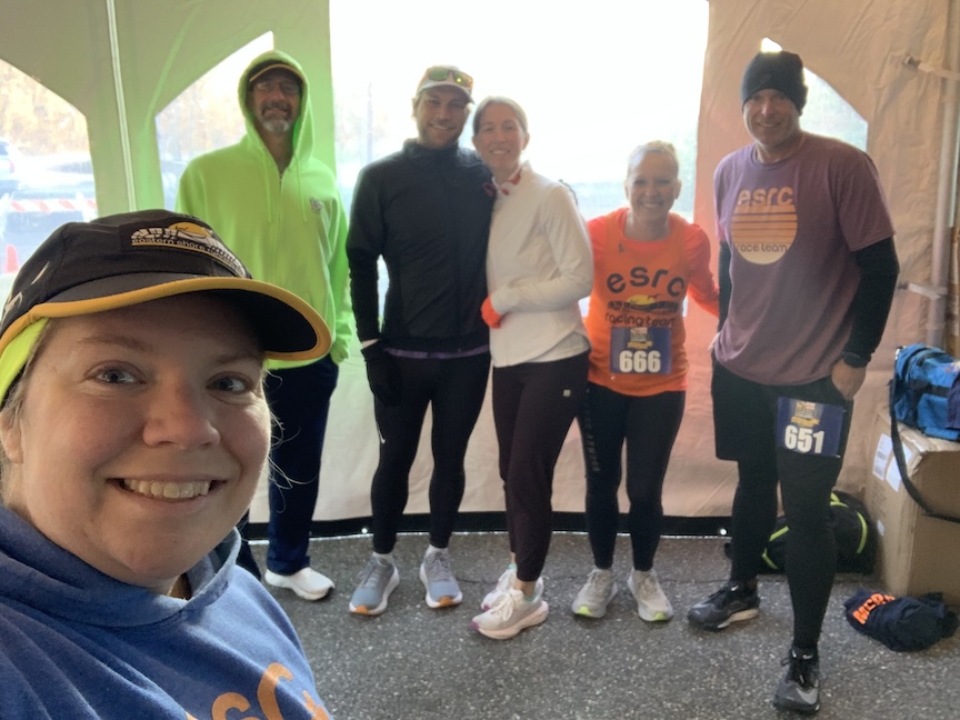 Group selfie of six runners dressed for winter weather.