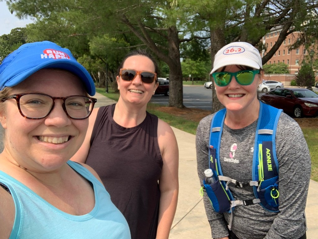 Three runners pose for a selfie. 