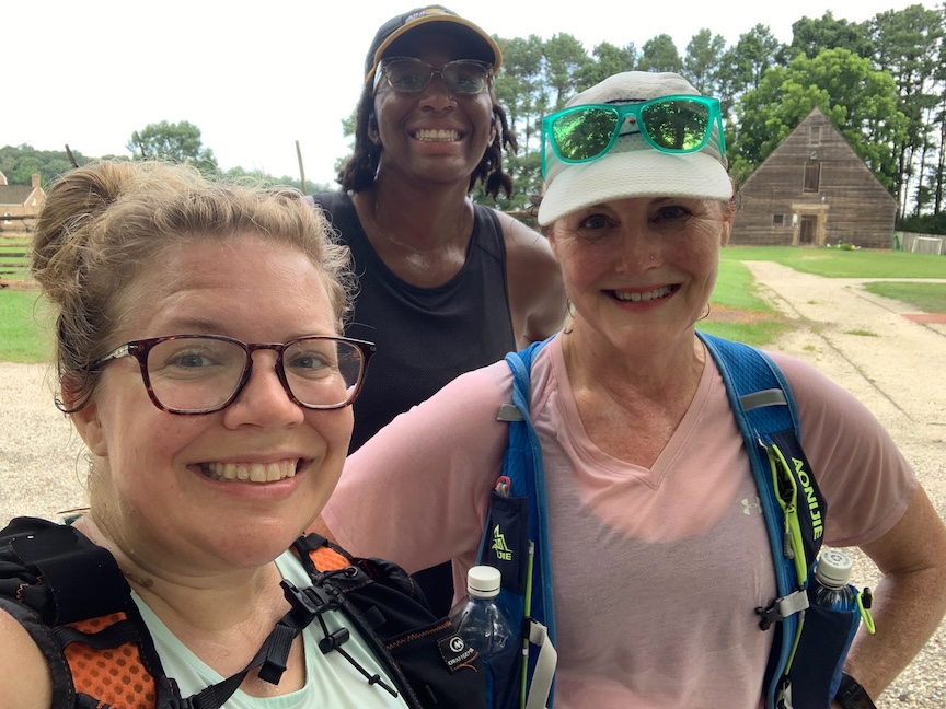 Three female runners smiling after a hot run. 