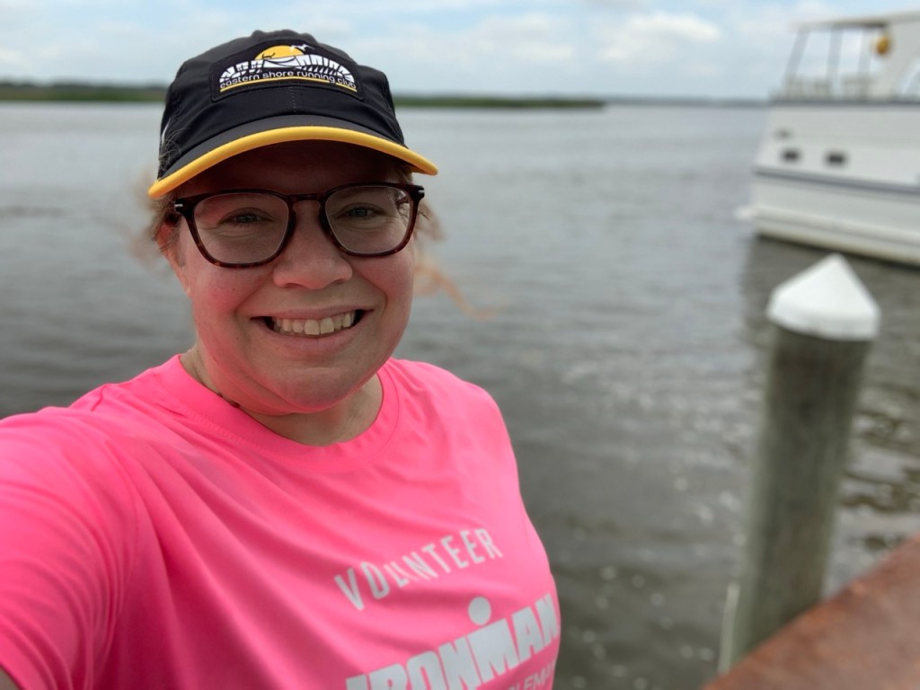 Selfie of smiling female runner with a waterway in the background. 
