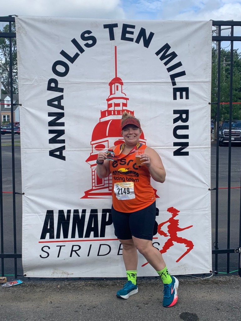 Vanessa Junkin poses by the Annapolis Ten Mile Run banner.