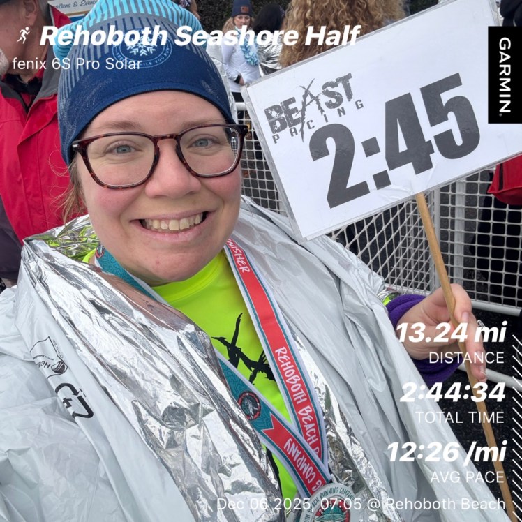 Selfie of Vanessa with her Beast Pacing sign and race stats after pacing the Rehoboth Beach Seashore Half Marathon