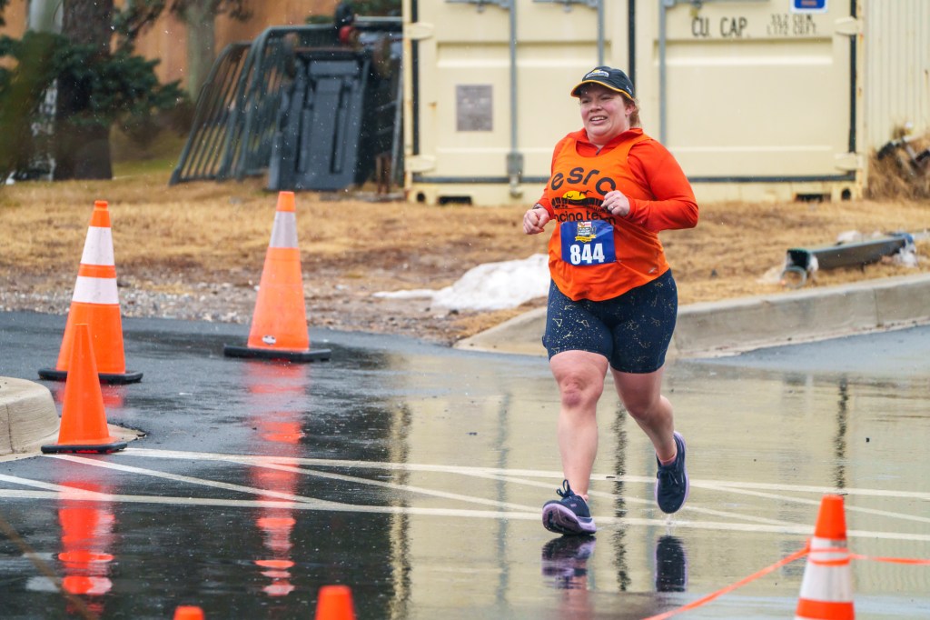 Female runner heads toward the finish line in a race. 