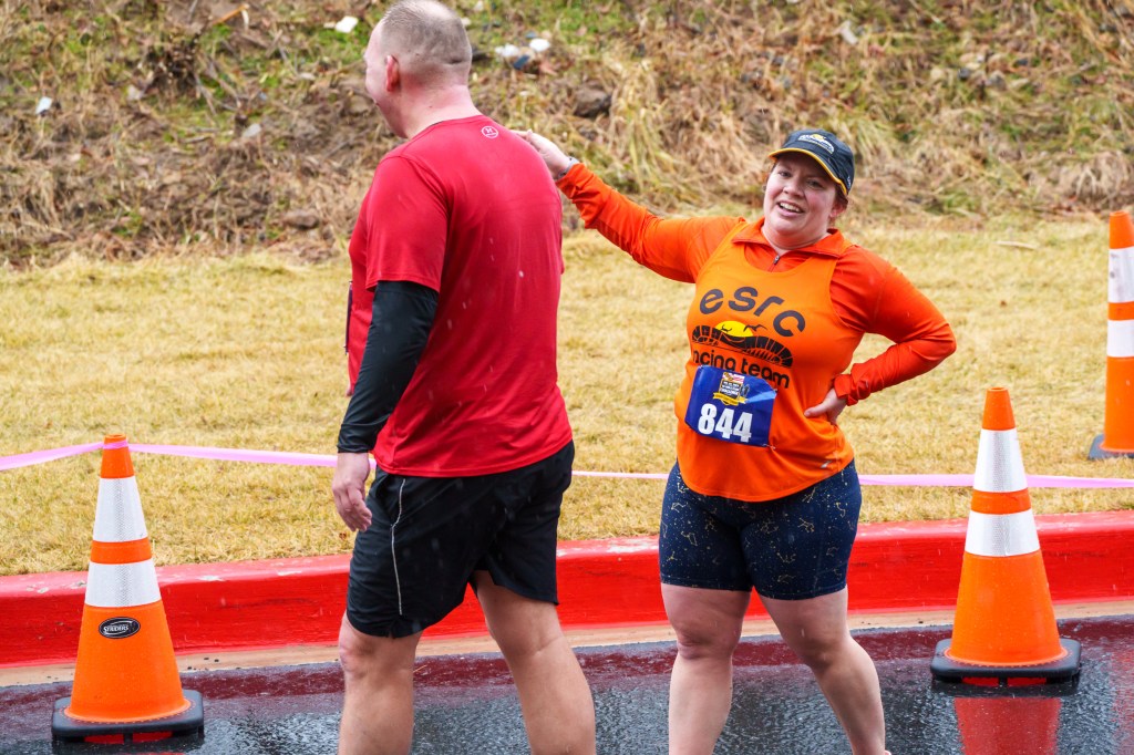 Side view of a high-five between two runners.