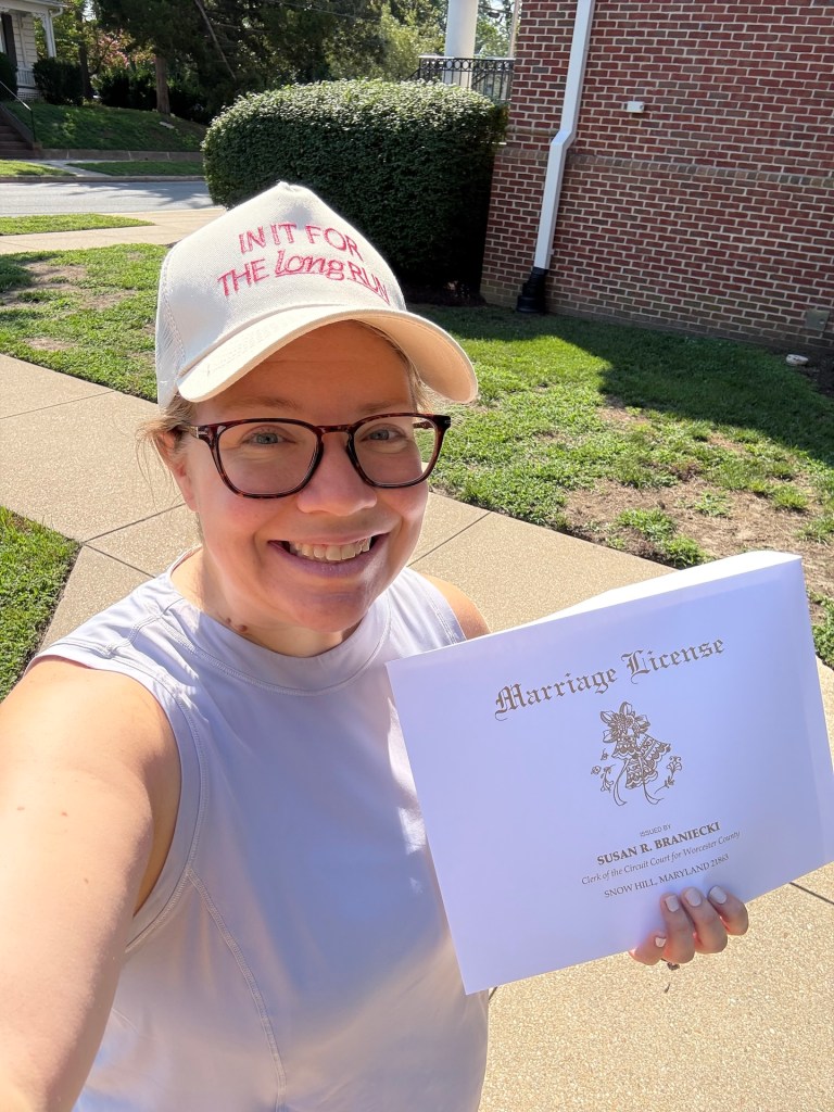 Female runner holding marriage license envelope